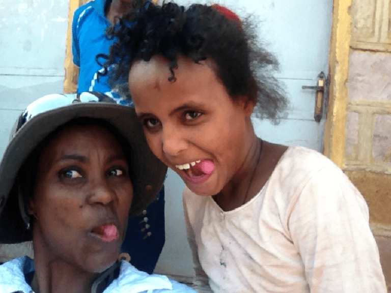 Shegitu and refugee girl make faces