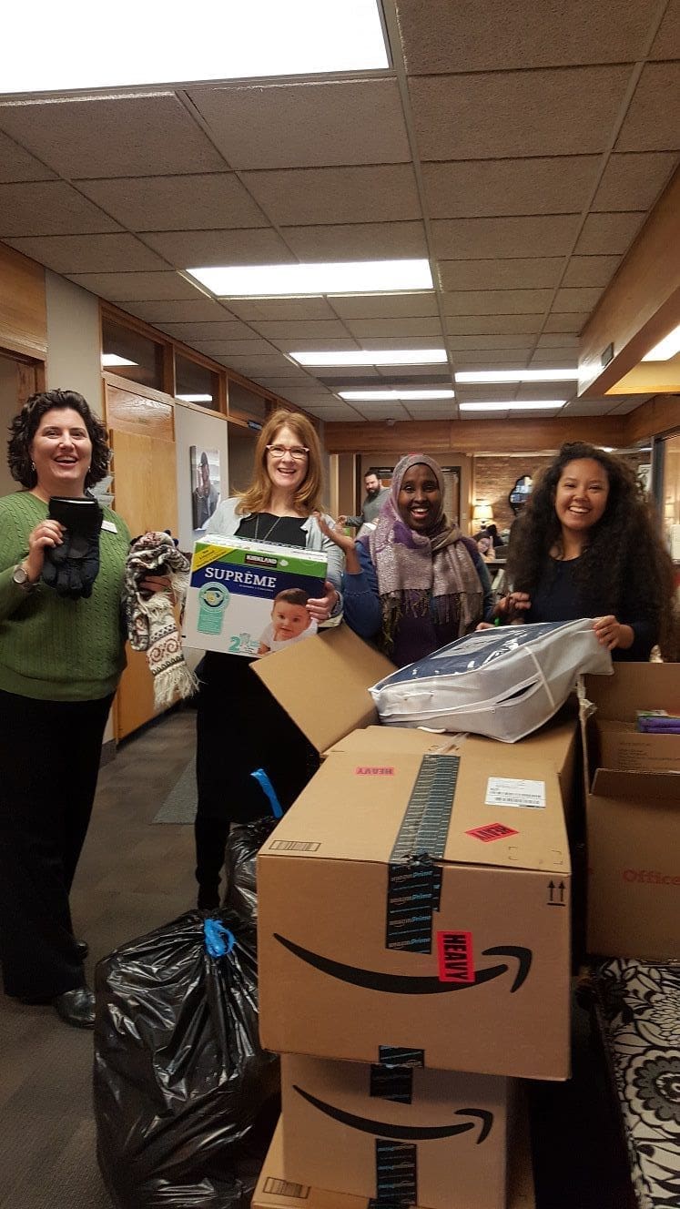Institute staff with a pile of donations