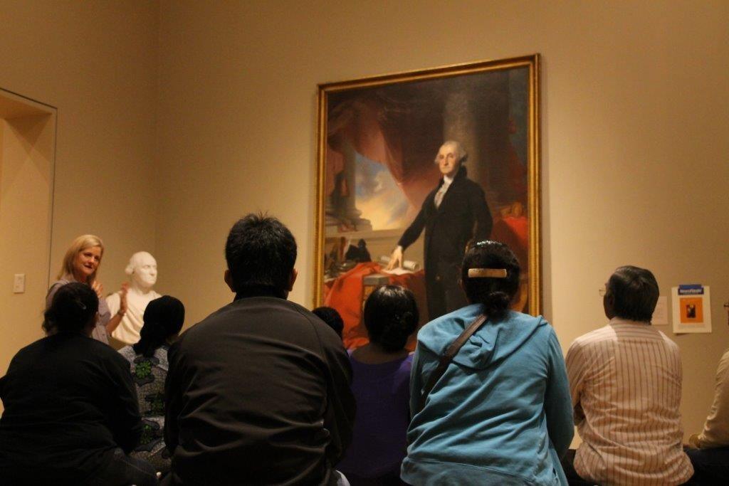 New Citizens in front of George Washington's portrait