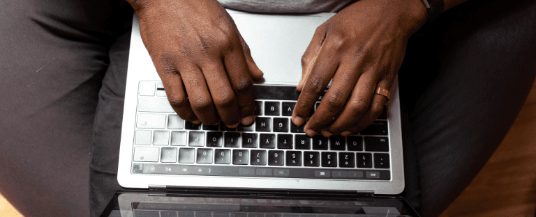 A person's hands on laptop keyboard