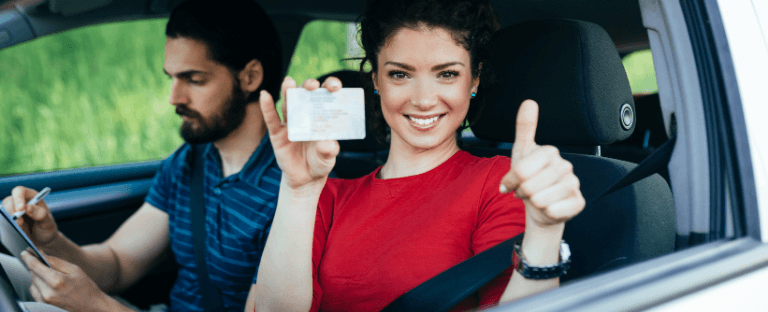 Woman shows new driver's license in car