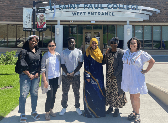 Students from around the world stand in front of Saint Paul College