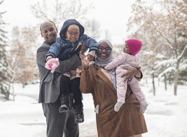 Portrait of immigrant family enjoying the snow