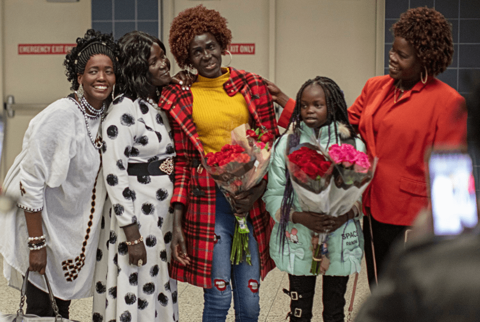 A refugee family of women reunited at the airport.
